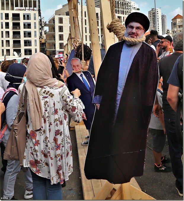 31719542-8607361-Cardboard_cut_outs_of_Hezbollah_leader_Hassan_Nasrallah_and_Isra-a-15_1596909210041